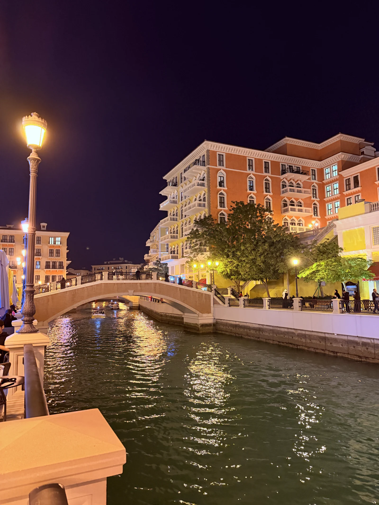 Le canal de Qanat Quartier au crépuscule, pont éclairé et façades pastel